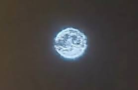 Bright object hovering approximately 45 meters above a tree line in New Jersey, described as the size of a school bus and highly unusual.